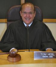 Judge Tom Hebl seated at bench in his robes